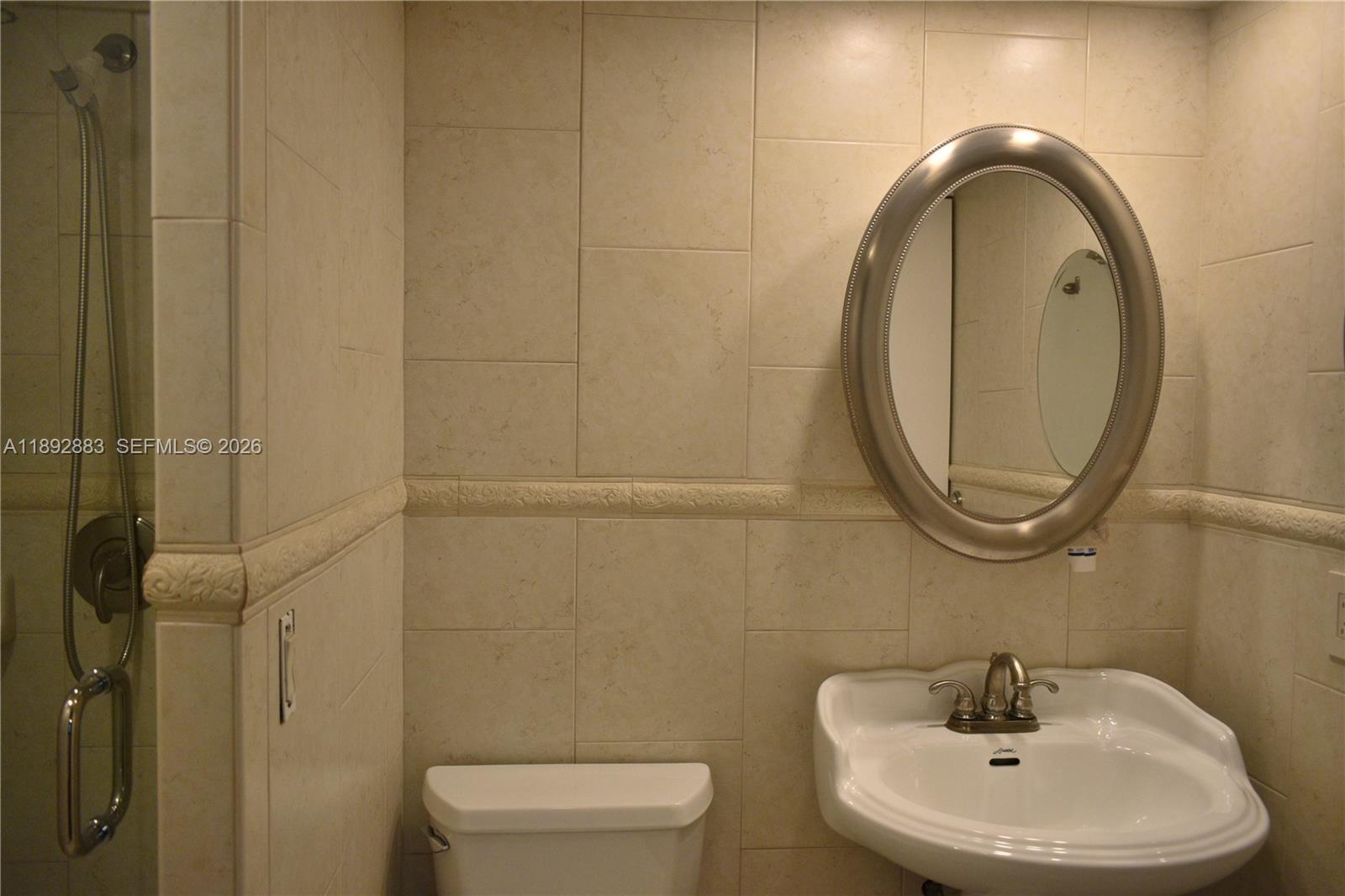 2011 Cornwall East, Unit A Boca Raton, FL 33434 - Photo 10 of 19 a bathroom with a sink a toilet and a mirror