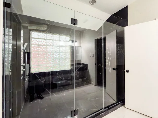 a bathroom with a bathtub and a shower