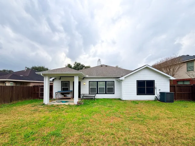 a front view of a house with a garden and yard