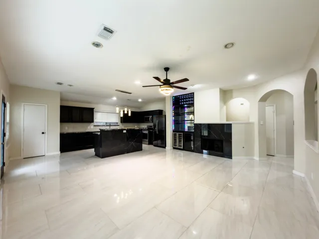 a large room with fireplace and windows