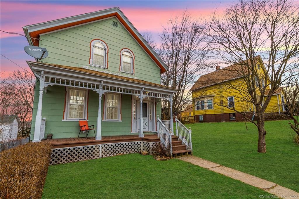 a front view of a house with a garden