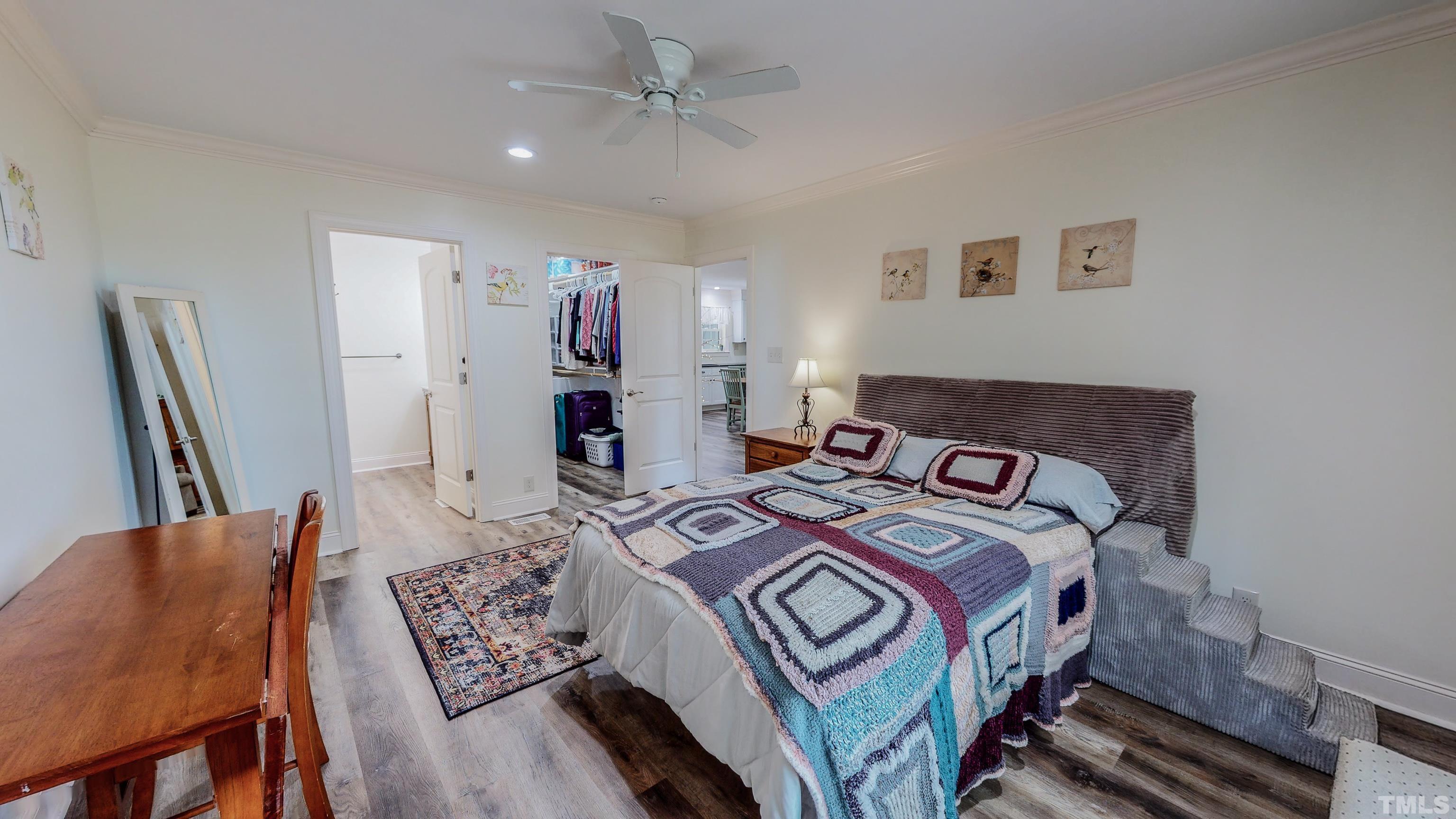 7402 Deer Crossing Road Rougemont, NC 27572 - Photo 15 of 54 a bedroom with a bed and a chandelier