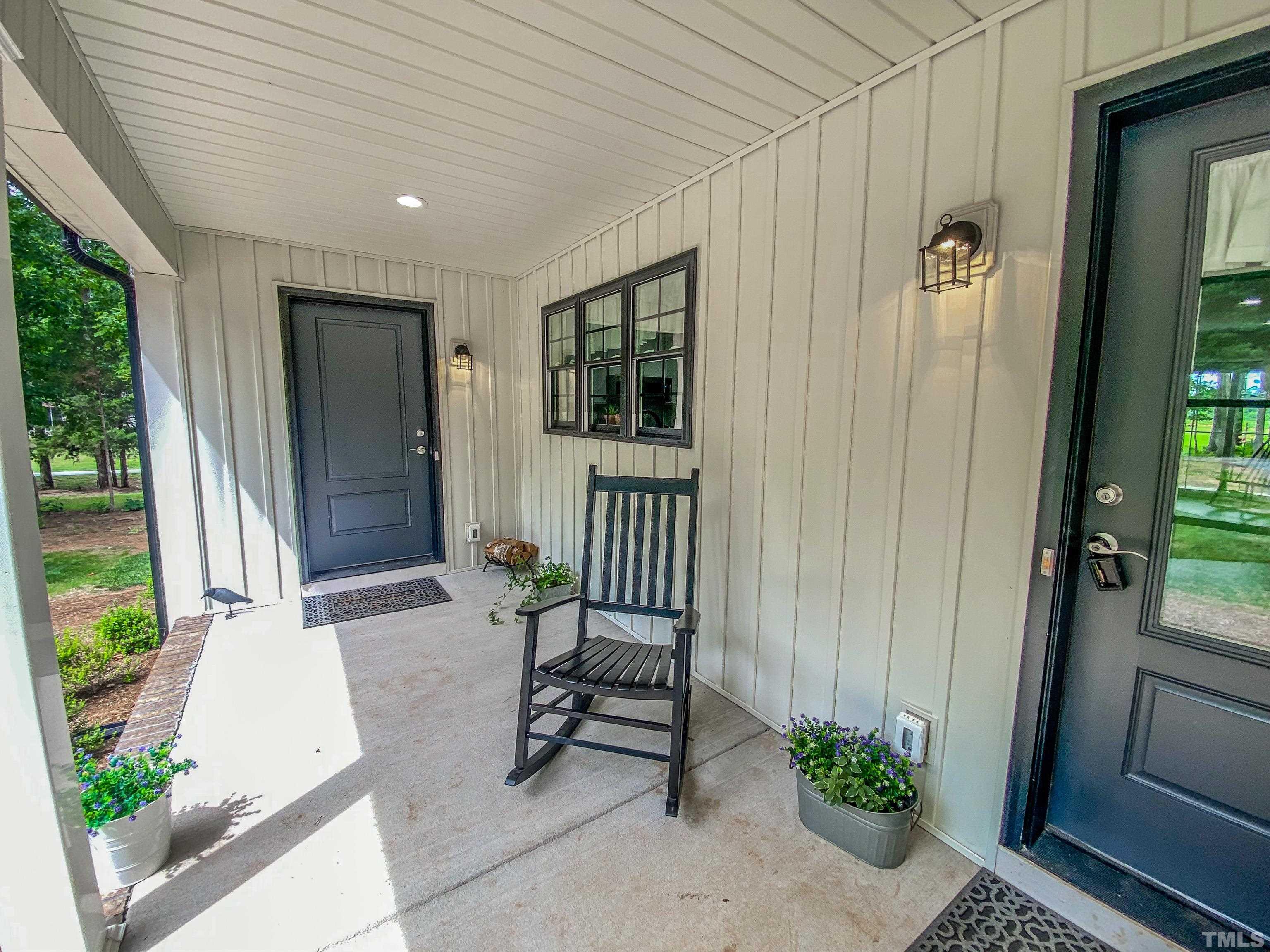 7402 Deer Crossing Road Rougemont, NC 27572 - Photo 23 of 54 a view of a door and chair in front of a house