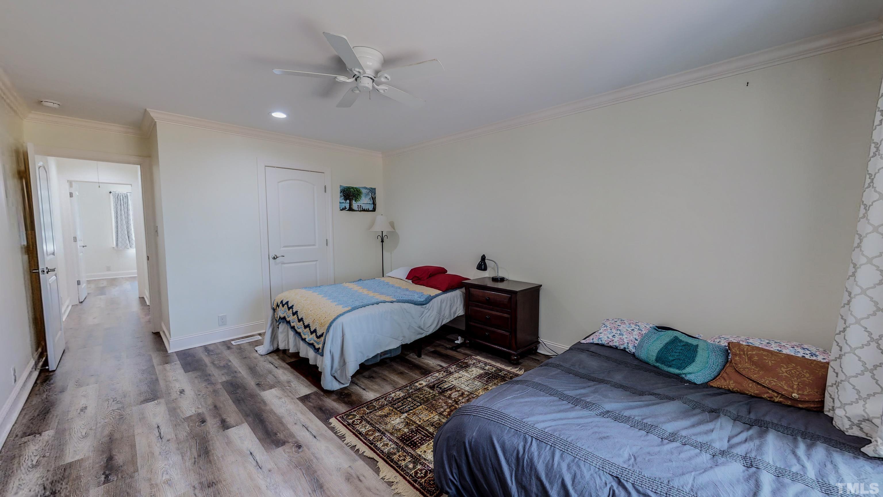 7402 Deer Crossing Road Rougemont, NC 27572 - Photo 25 of 54 a bedroom with a bed and wooden floor