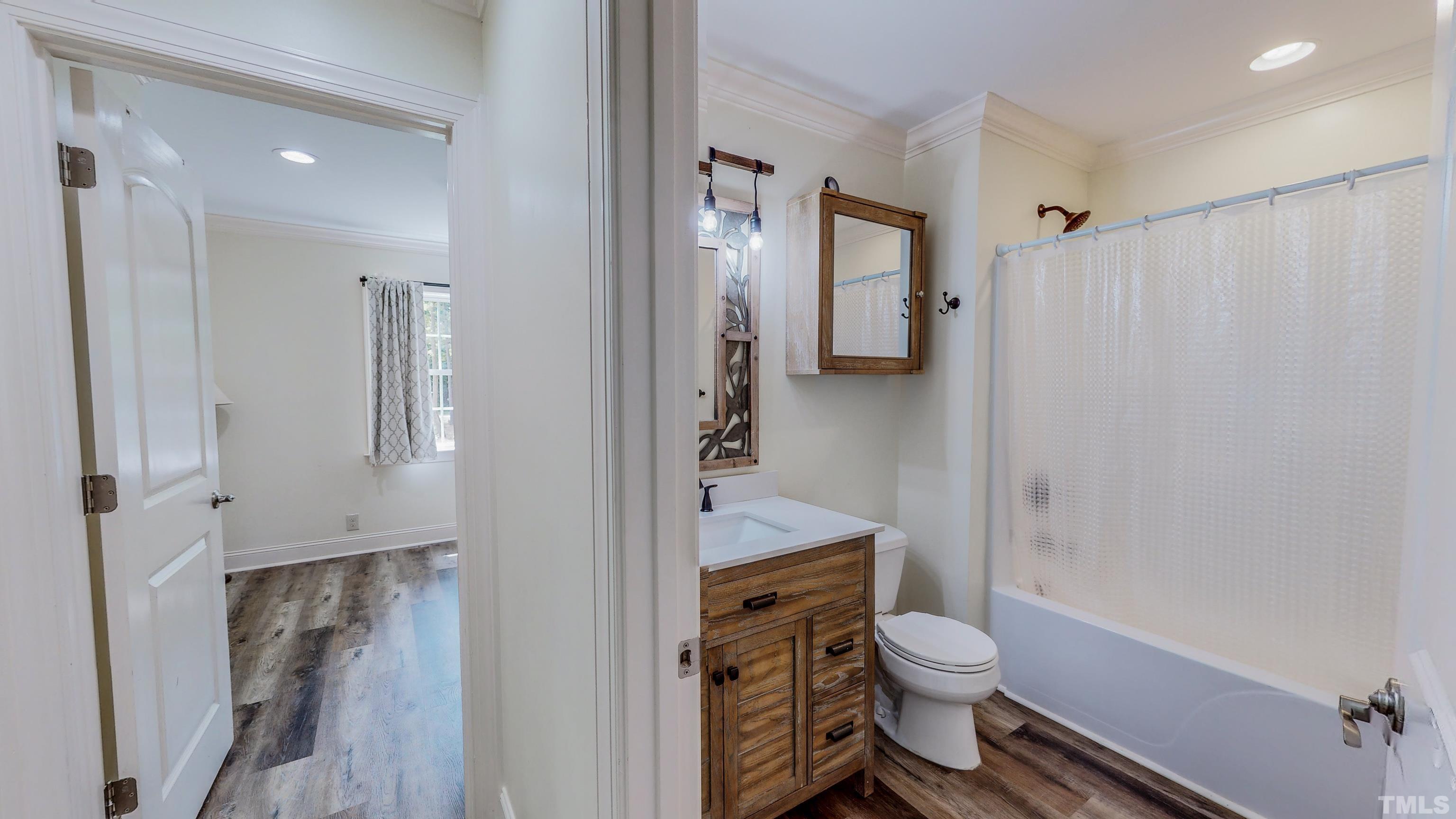 7402 Deer Crossing Road Rougemont, NC 27572 - Photo 27 of 54 a bathroom with a granite countertop toilet a sink and a shower