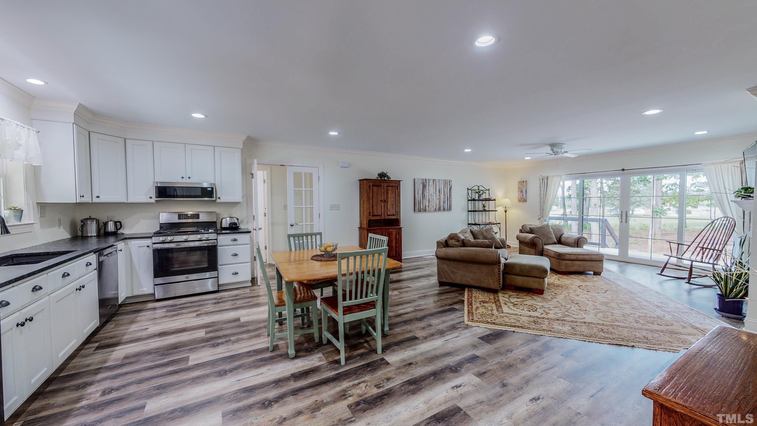 7402 Deer Crossing Road Rougemont, NC 27572 - Photo 3 of 54 a living room with furniture appliances and a dining table with wooden floor