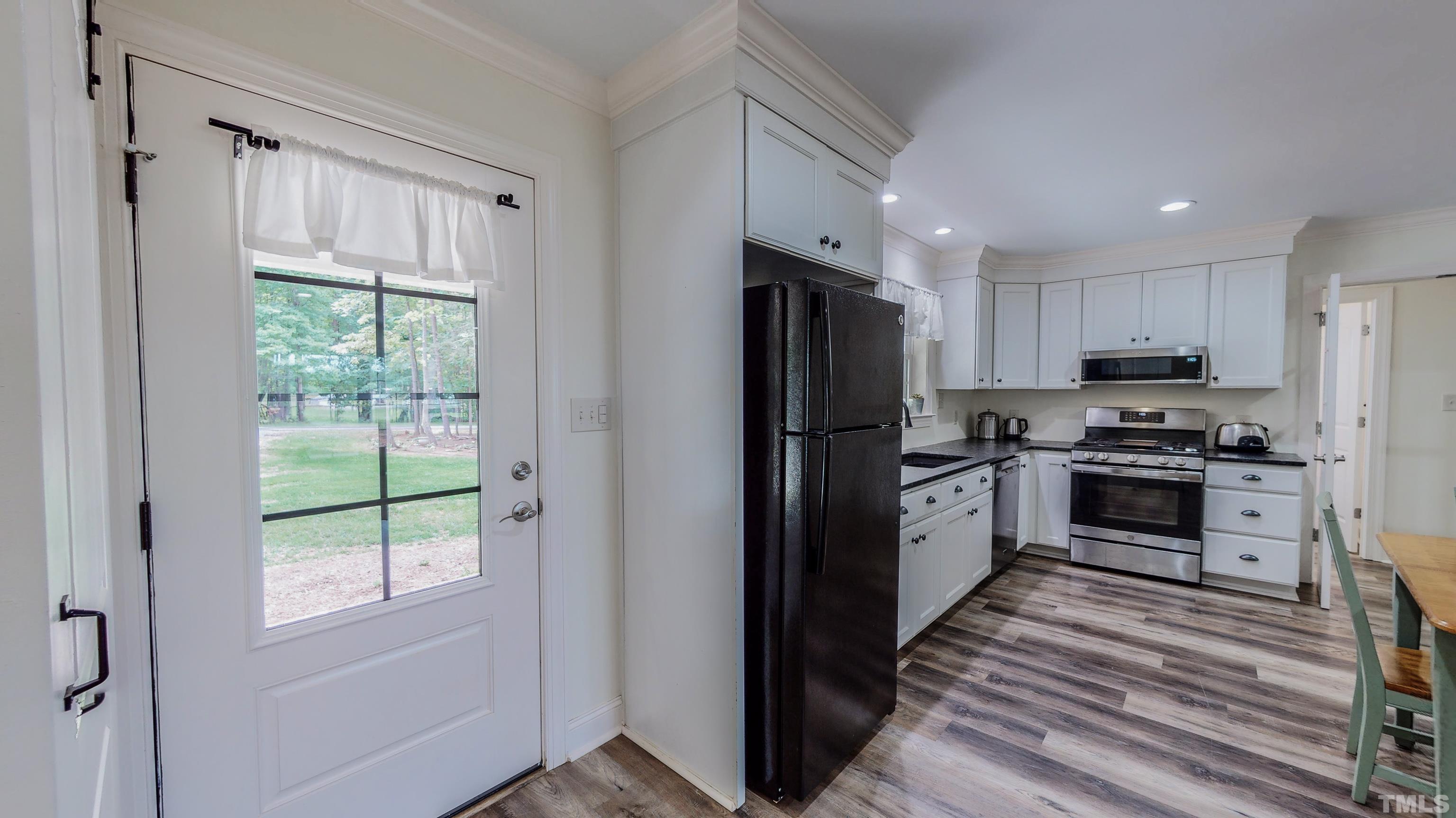 7402 Deer Crossing Road Rougemont, NC 27572 - Photo 35 of 54 a kitchen with a refrigerator a stove top oven