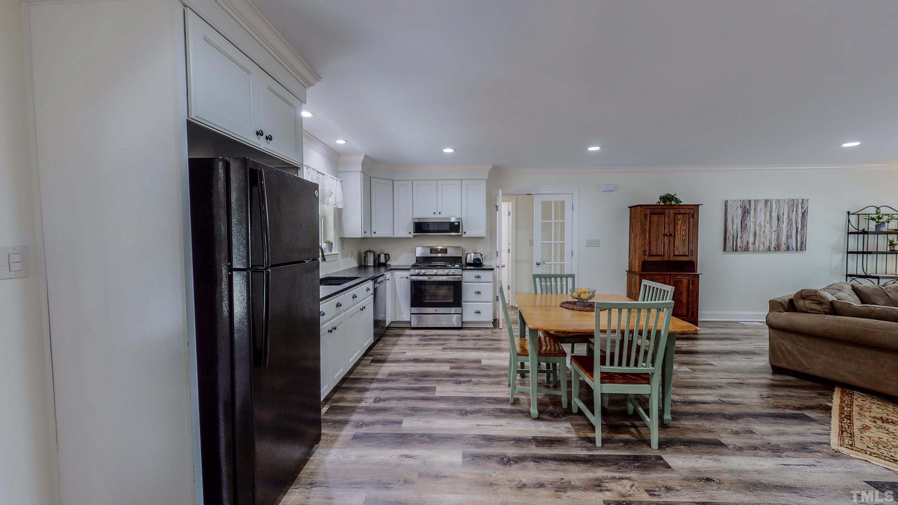 7402 Deer Crossing Road Rougemont, NC 27572 - Photo 36 of 54 a kitchen with stainless steel appliances granite countertop a refrigerator and a stove top oven