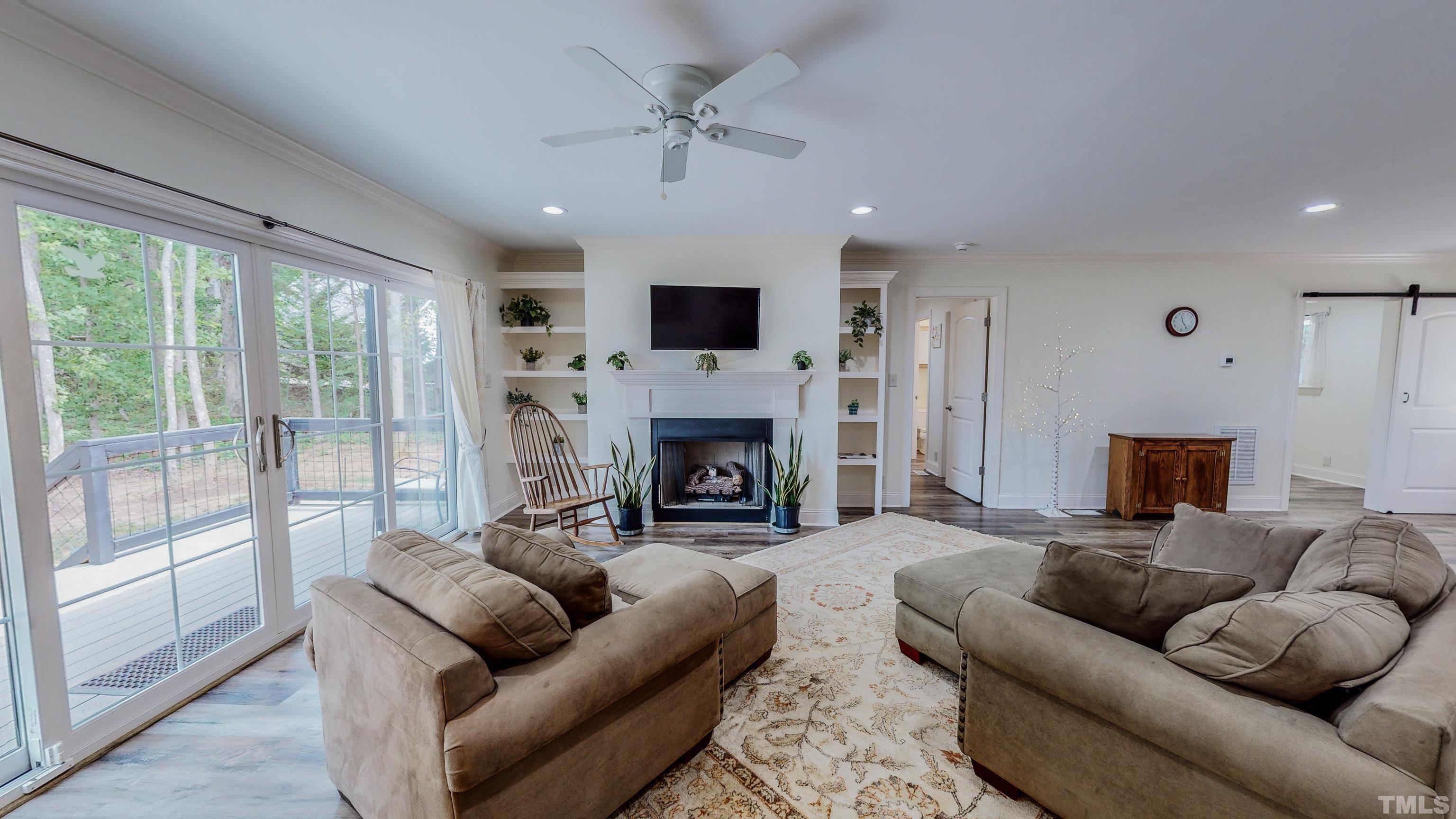 7402 Deer Crossing Road Rougemont, NC 27572 - Photo 38 of 54 a living room with furniture a large window and a fireplace