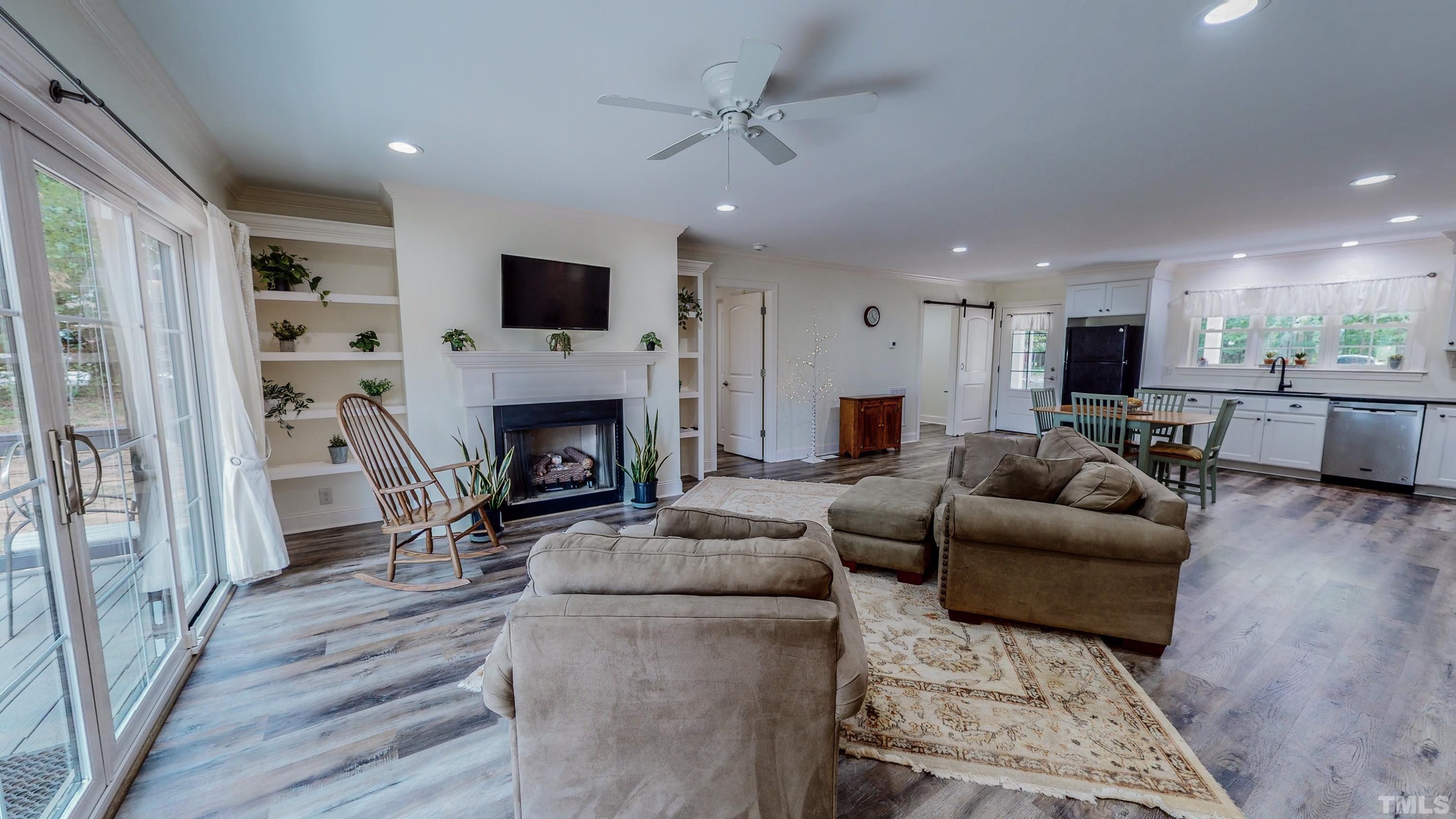 7402 Deer Crossing Road Rougemont, NC 27572 - Photo 40 of 54 a living room with furniture a flat screen tv and a fireplace