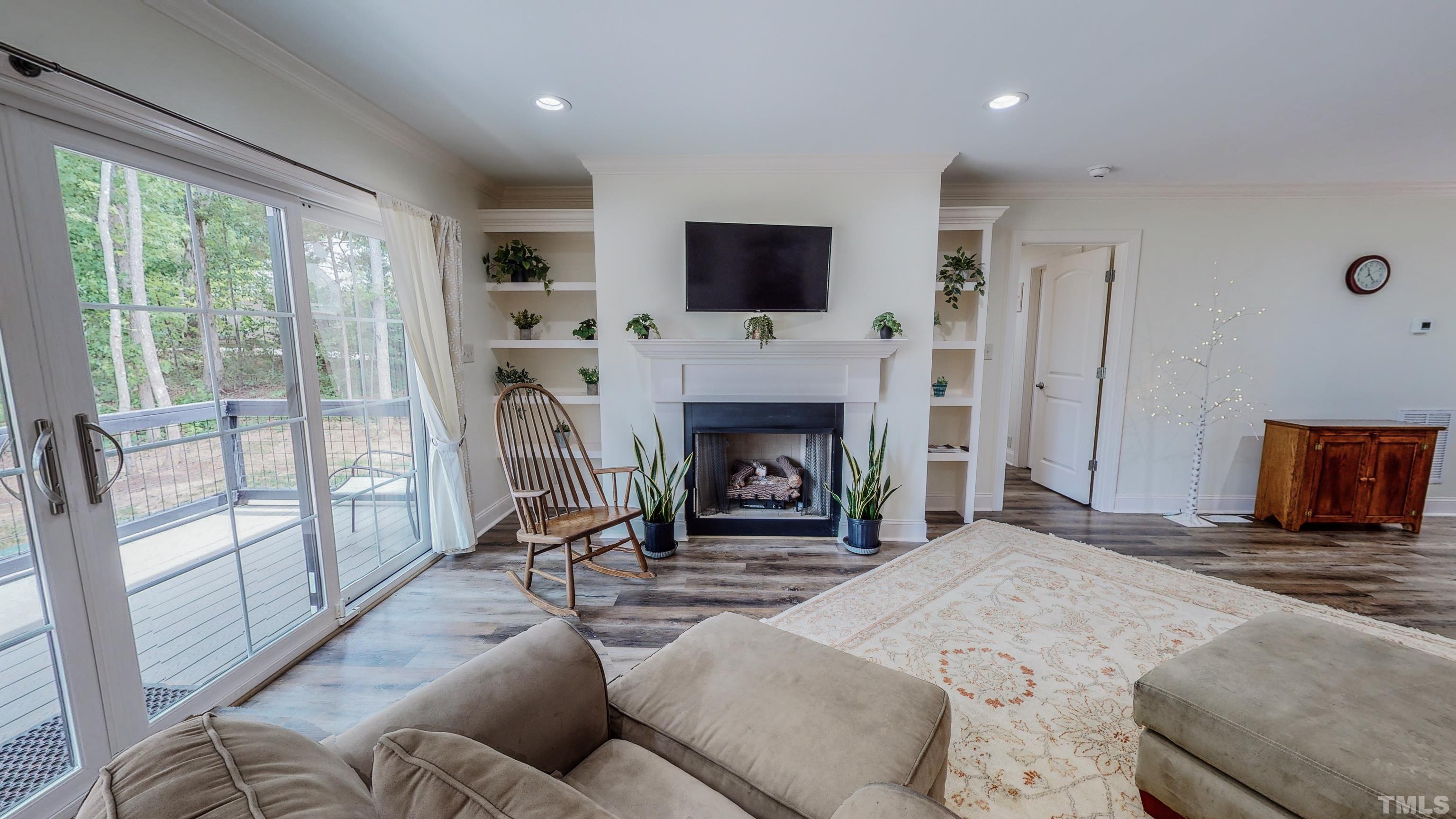 7402 Deer Crossing Road Rougemont, NC 27572 - Photo 42 of 54 a living room with fireplace furniture and a flat screen tv