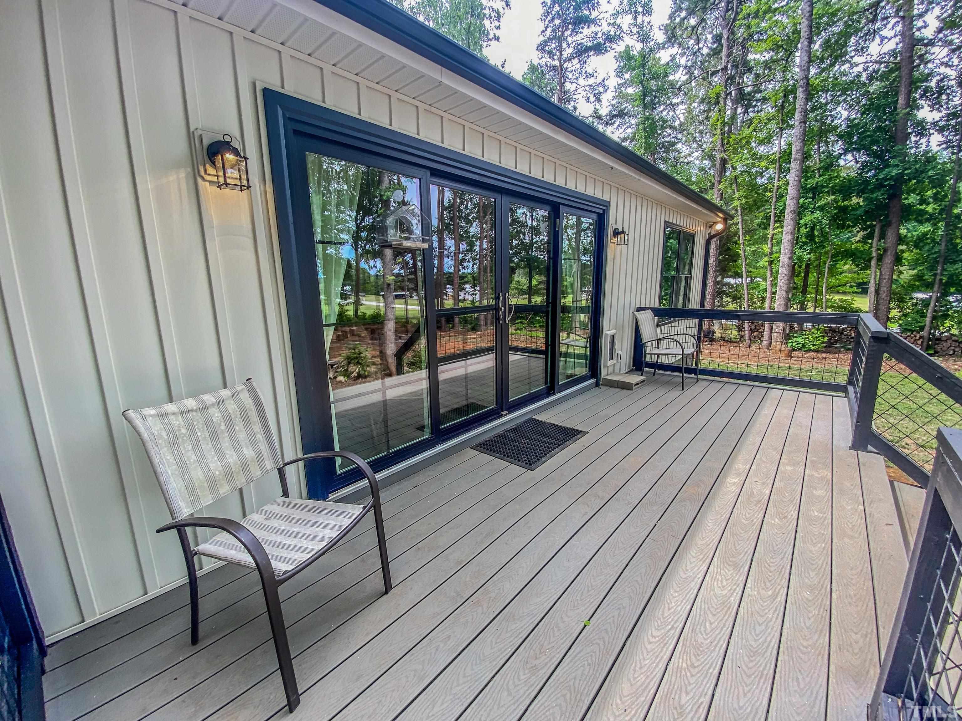 7402 Deer Crossing Road Rougemont, NC 27572 - Photo 44 of 54 a view of a house with wooden deck and furniture