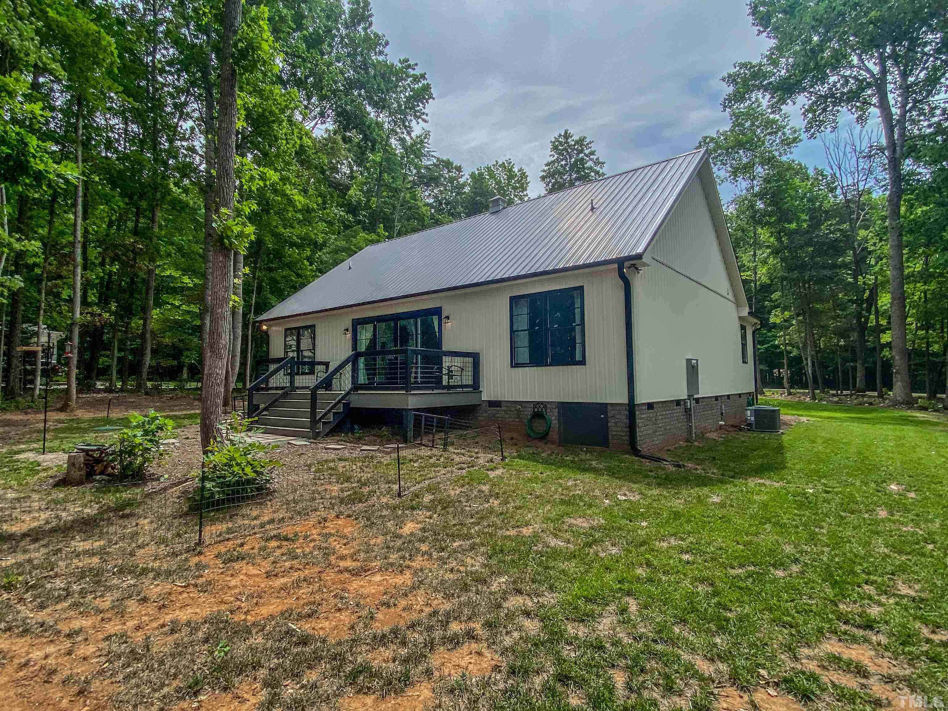 7402 Deer Crossing Road Rougemont, NC 27572 - Photo 50 of 54 a view of a house with backyard and a tree