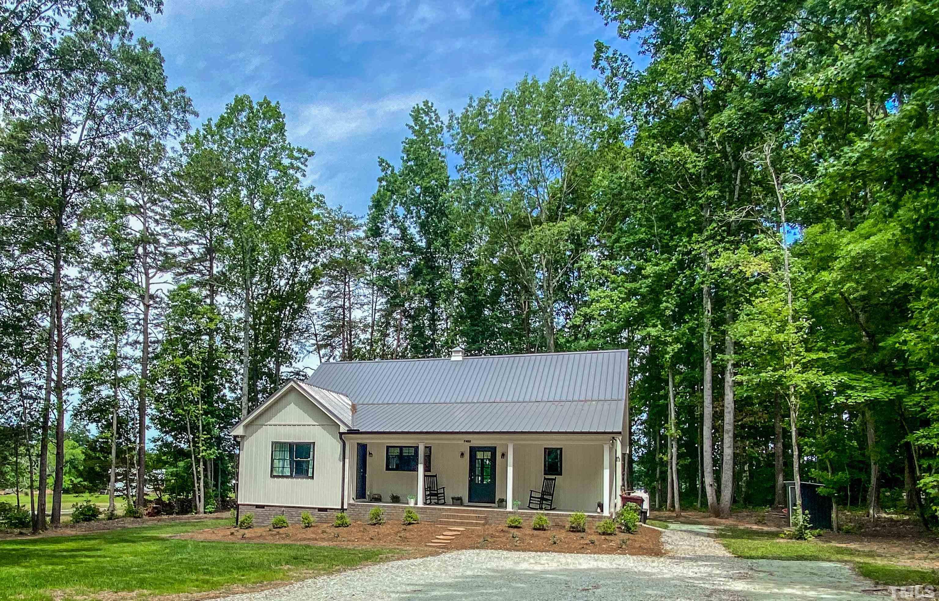 7402 Deer Crossing Road Rougemont, NC 27572 - Photo 54 of 54 a view of a white house with a big yard and large trees