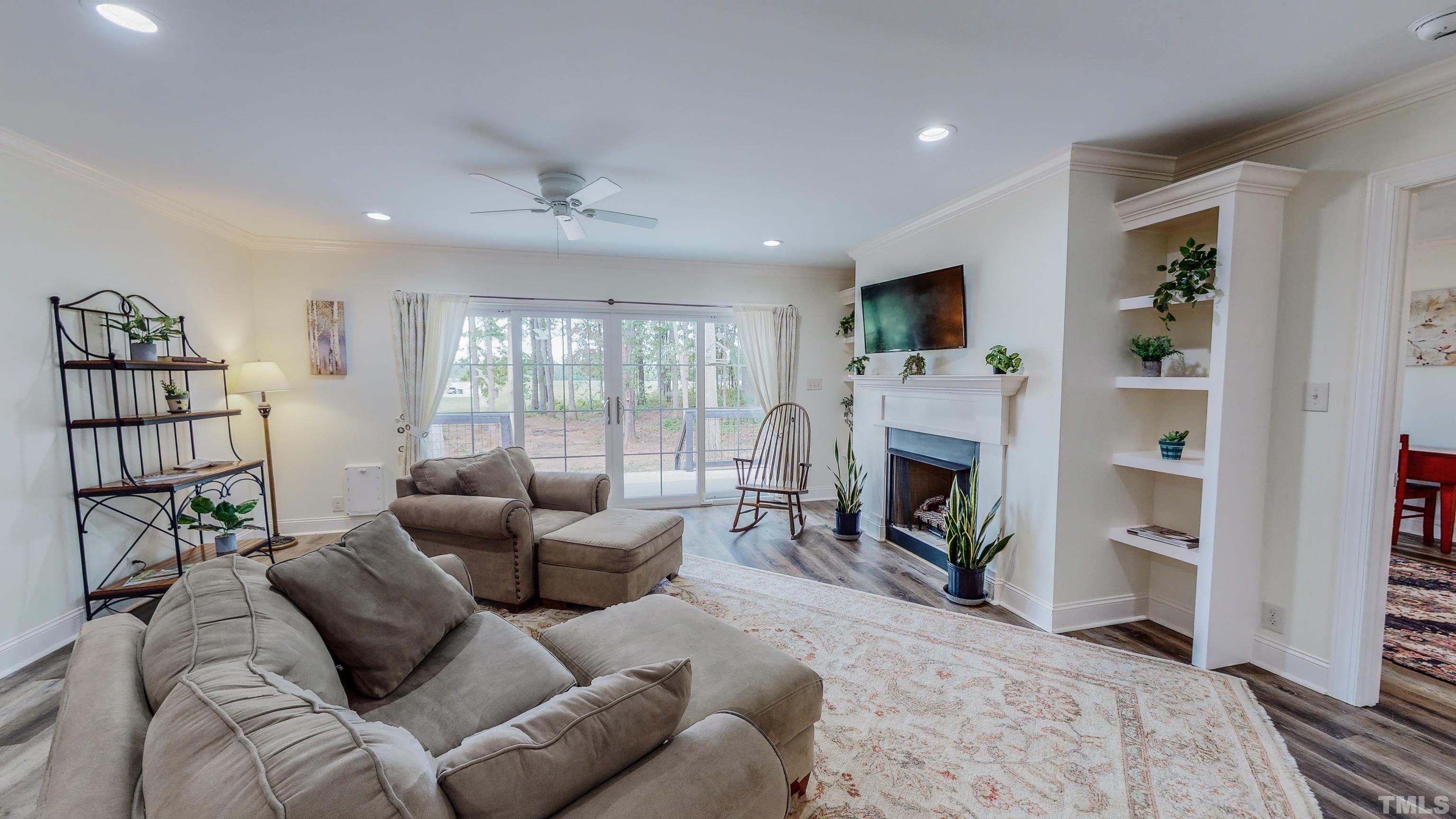 7402 Deer Crossing Road Rougemont, NC 27572 - Photo 6 of 54 a living room with furniture a flat screen tv and a fireplace