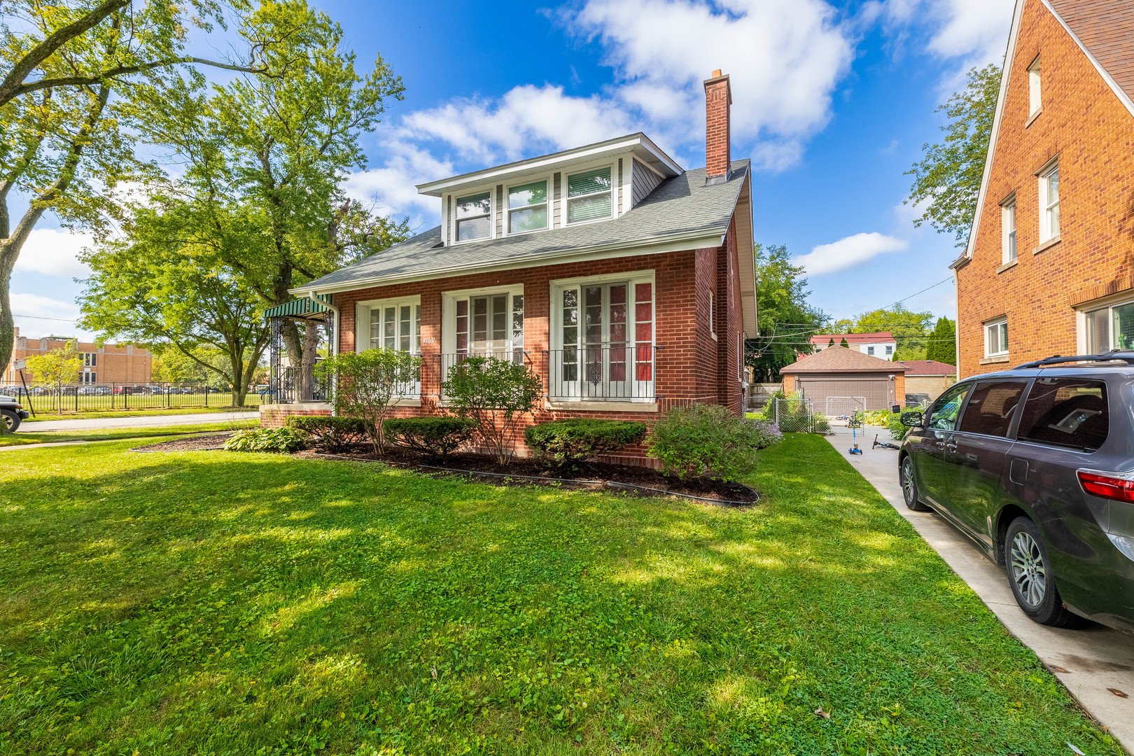 a front view of a house with garden and porch
