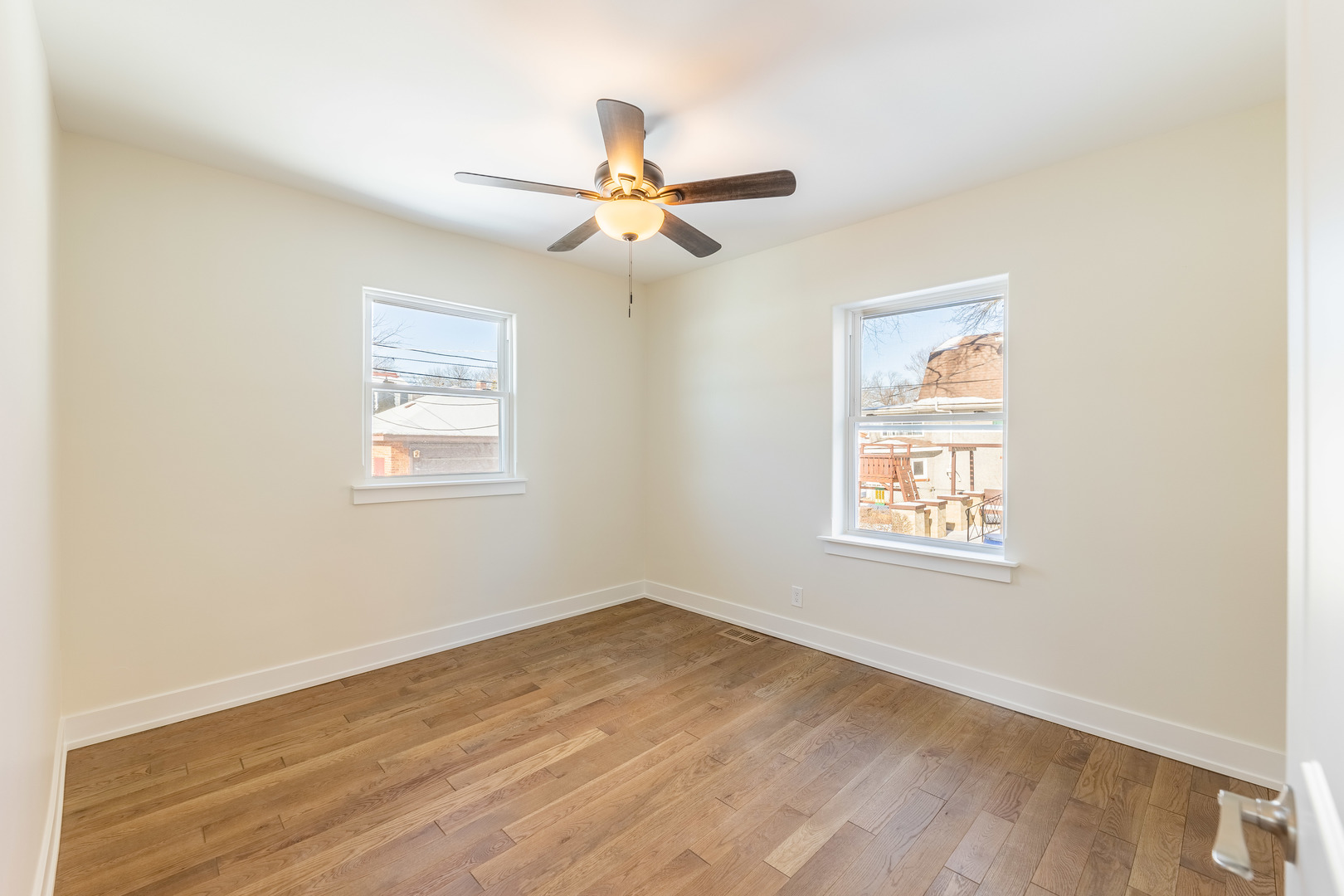 9160 South Hamilton Avenue Chicago, IL 60643 - Photo 17 of 53 an empty room with wooden floor ceiling fan and windows