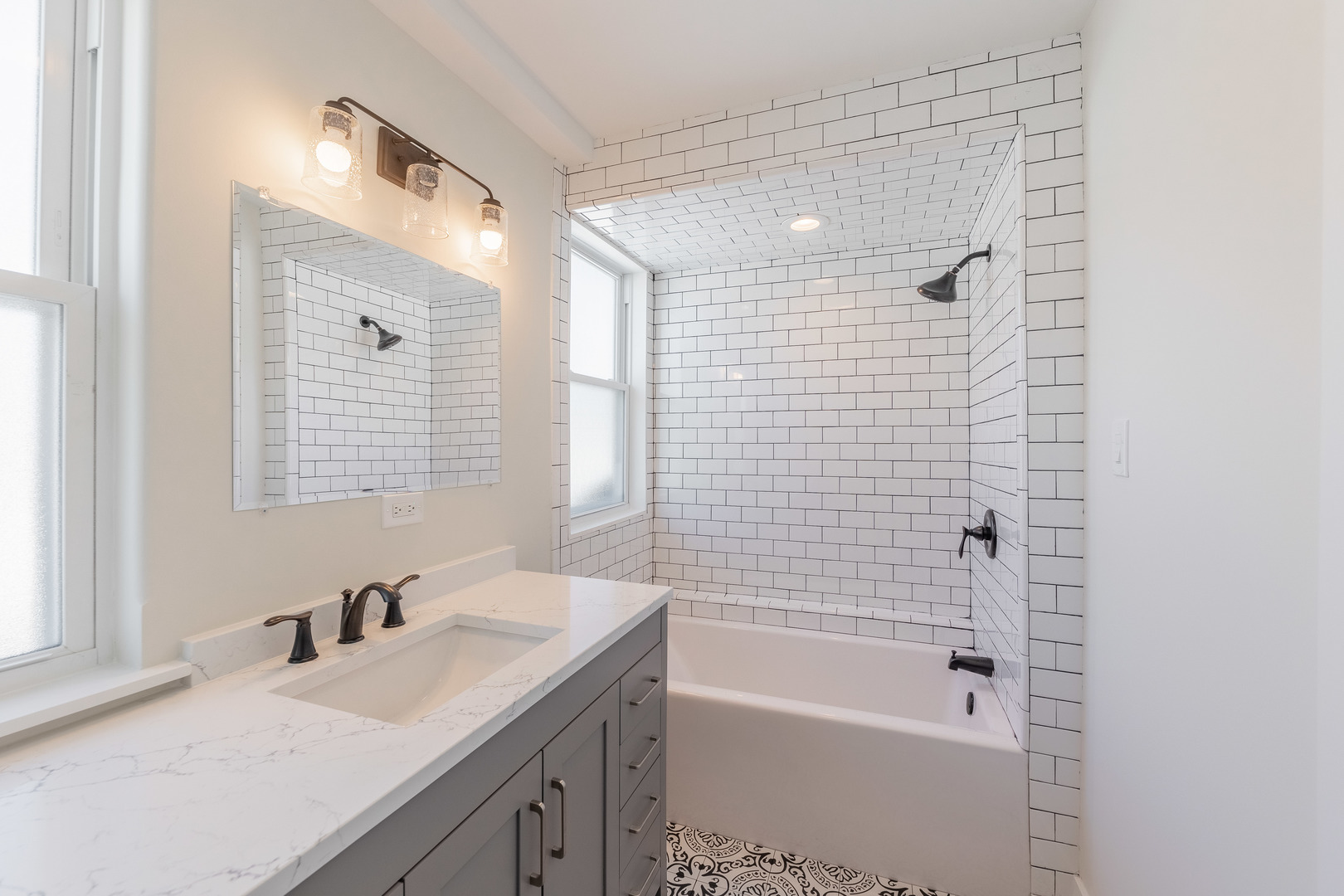 9160 South Hamilton Avenue Chicago, IL 60643 - Photo 29 of 53 a bathroom with a granite countertop sink a mirror a bathtub and next to a window