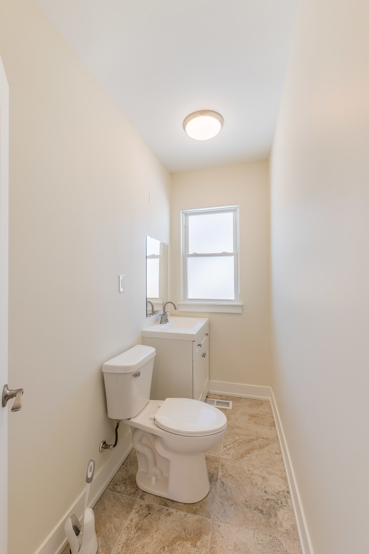 9160 South Hamilton Avenue Chicago, IL 60643 - Photo 36 of 53 a white toilet sitting next to a bathroom sink and vanity