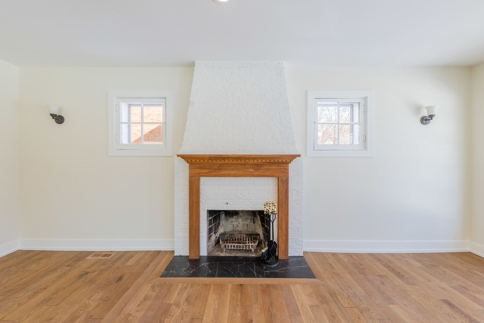 9160 South Hamilton Avenue Chicago, IL 60643 - Photo 8 of 53 a view of an empty room with wooden floor a fireplace and a window