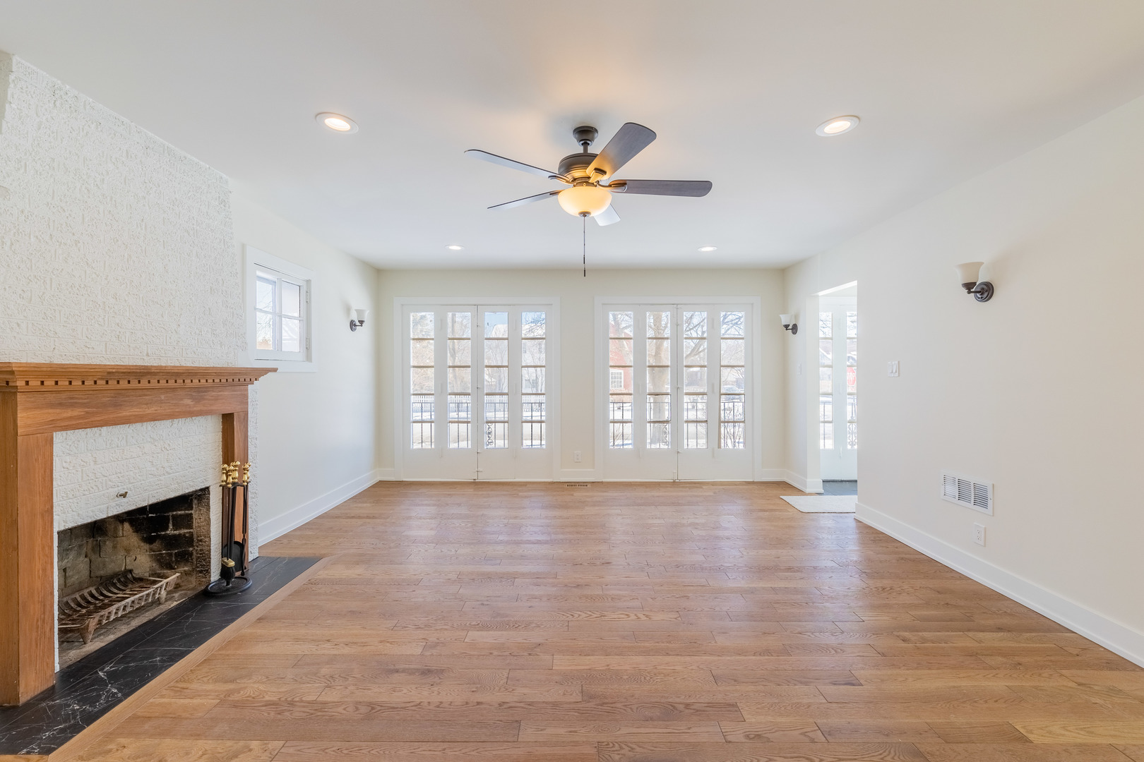9160 South Hamilton Avenue Chicago, IL 60643 - Photo 9 of 53 a view of an empty room with chandelier fan and wooden floor