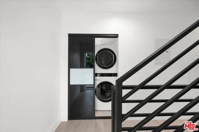 a view of a hallway with washer and dryer