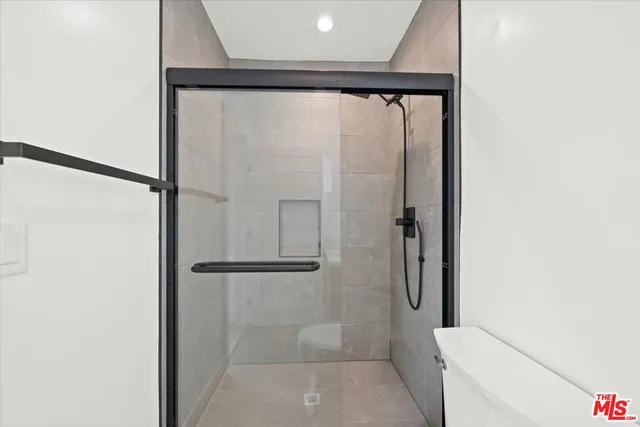 a bathroom with a glass shower door