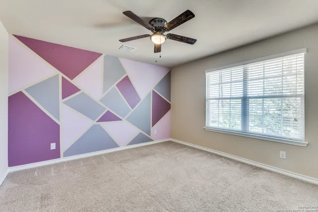 a view of an empty room with windows