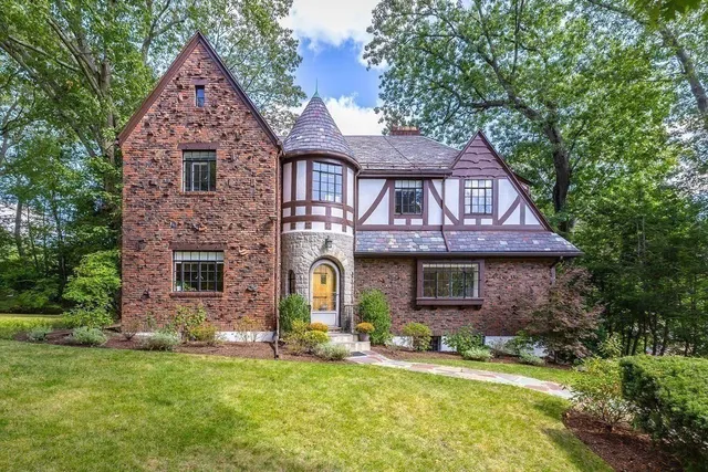 a front view of a house with a yard and garage