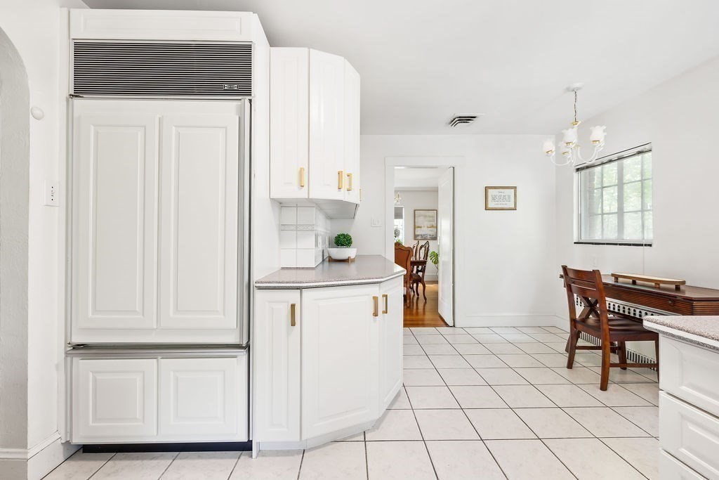 1069 West Roxbury Parkway Brookline, MA 02467 - Photo 11 of 27 a kitchen with white cabinets and white appliances