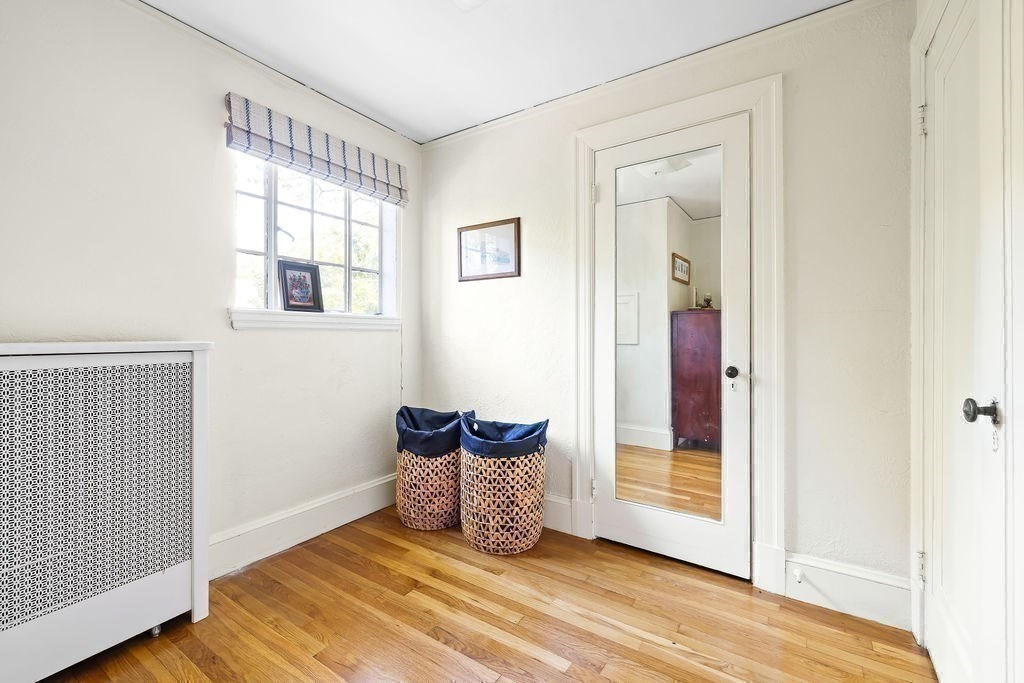 1069 West Roxbury Parkway Brookline, MA 02467 - Photo 16 of 27 an empty room with wooden floor and windows