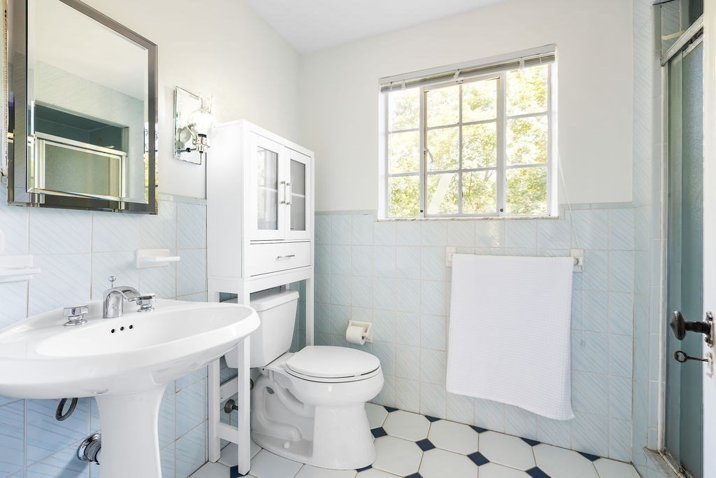 1069 West Roxbury Parkway Brookline, MA 02467 - Photo 17 of 27 a bathroom with a sink a toilet and shower