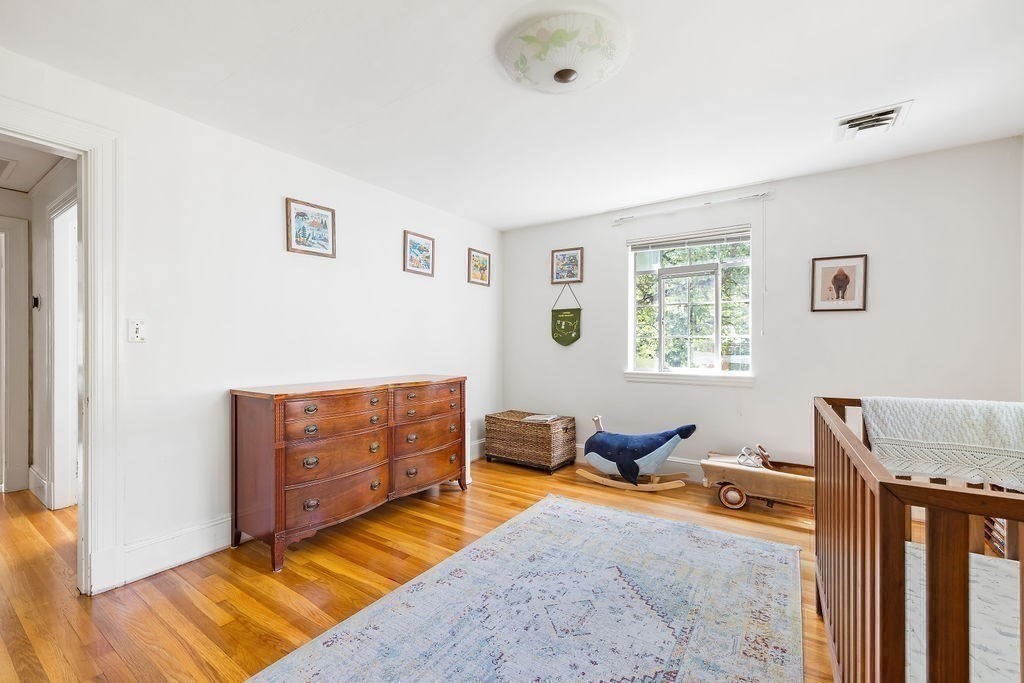 1069 West Roxbury Parkway Brookline, MA 02467 - Photo 20 of 27 a bedroom with furniture and a window