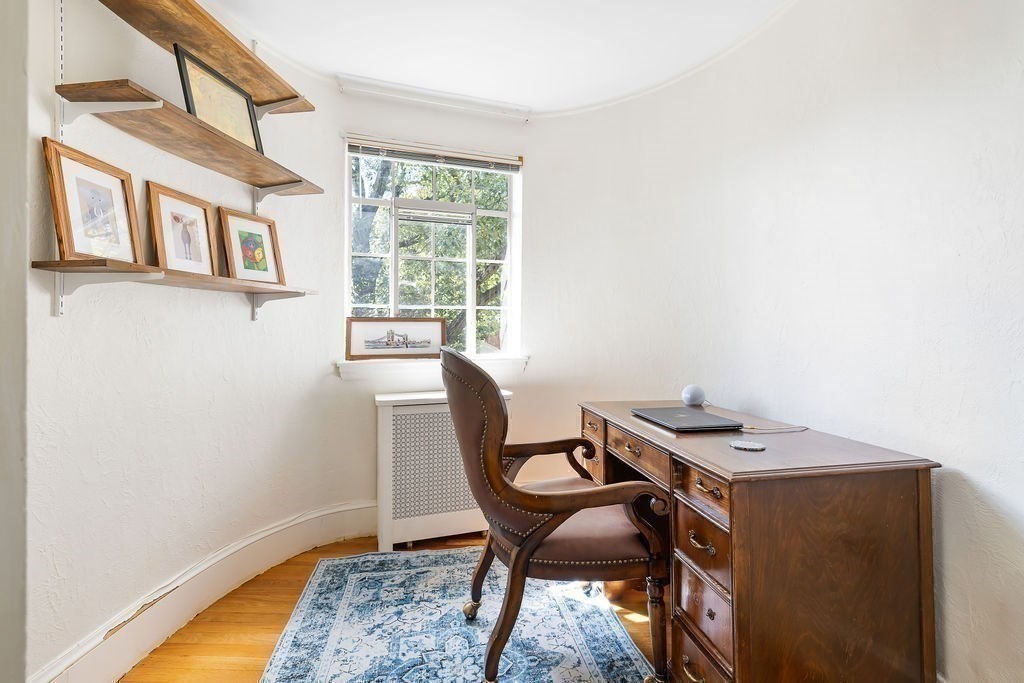 1069 West Roxbury Parkway Brookline, MA 02467 - Photo 21 of 27 a view of a dining room with furniture and a window
