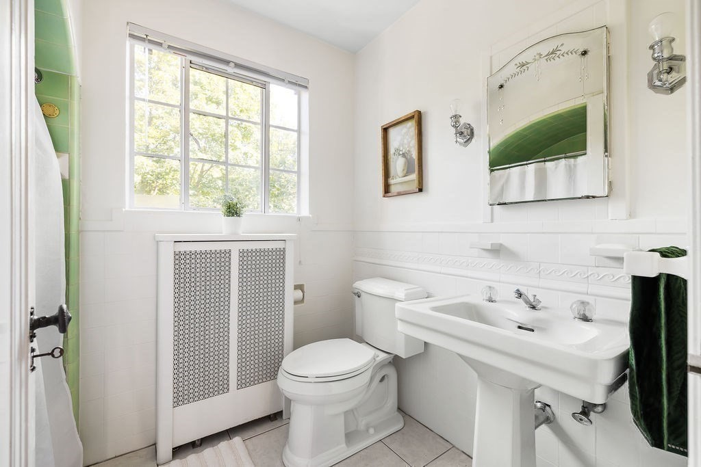 1069 West Roxbury Parkway Brookline, MA 02467 - Photo 22 of 27 a white toilet sitting next to a bathroom sink