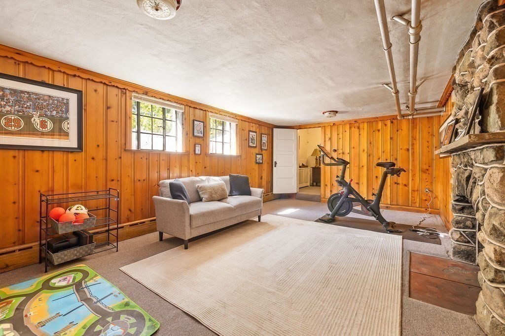 1069 West Roxbury Parkway Brookline, MA 02467 - Photo 23 of 27 a living room with furniture a rug and a flat screen tv