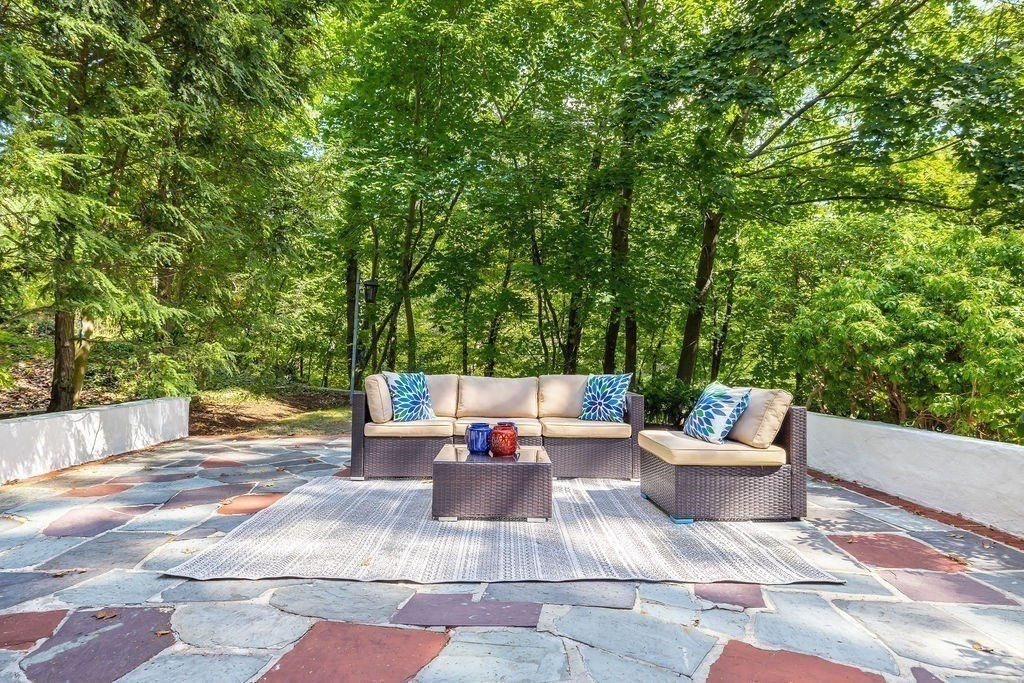 1069 West Roxbury Parkway Brookline, MA 02467 - Photo 25 of 27 a view of a patio with a dining table and chairs