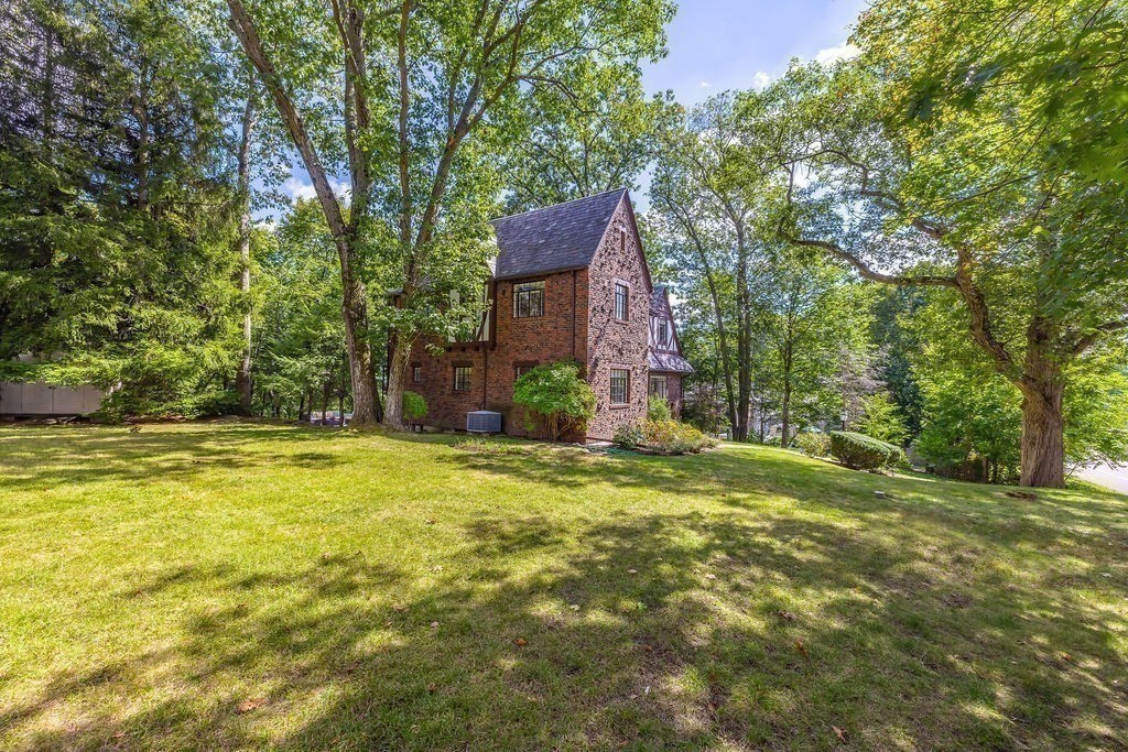 1069 West Roxbury Parkway Brookline, MA 02467 - Photo 26 of 27 a backyard of a house with table and chairs