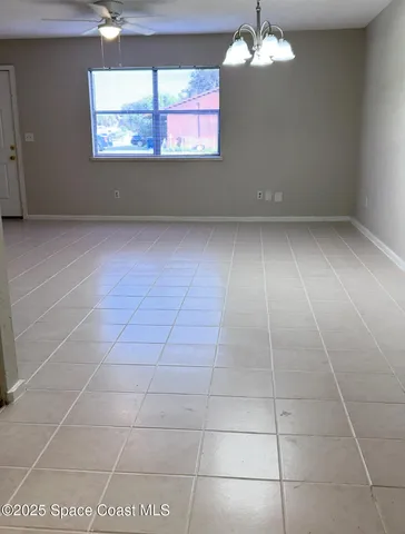 an empty room with a empty space and windows