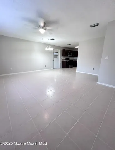 a view of a livingroom with furniture and a ceiling fan