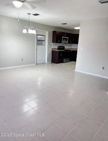 a large kitchen with cabinets and stainless steel appliances