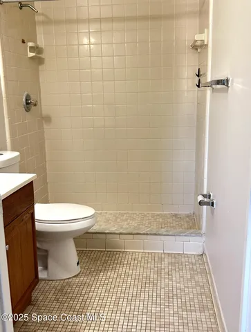 a bathroom with a toilet and a shower