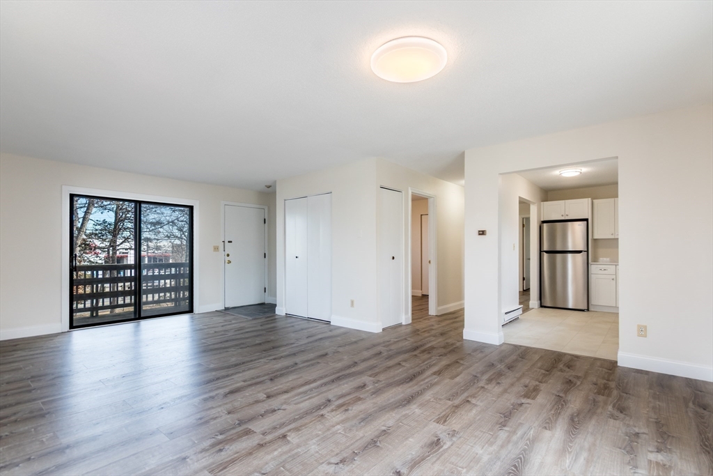 800 Bearses Way, Unit 3NE Hyannis, MA 02601 - Photo 1 of 20 an empty room with wooden floor and windows