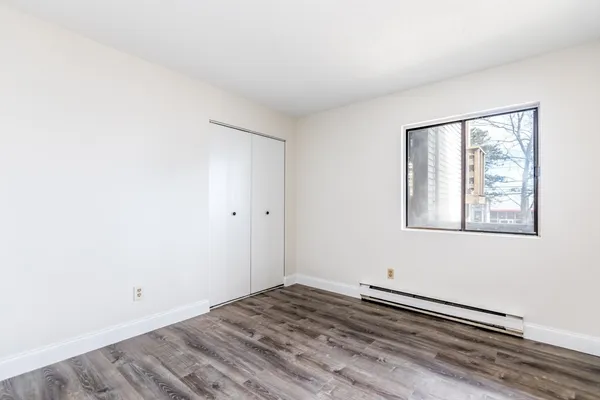 a view of a room with wooden floor and white walls