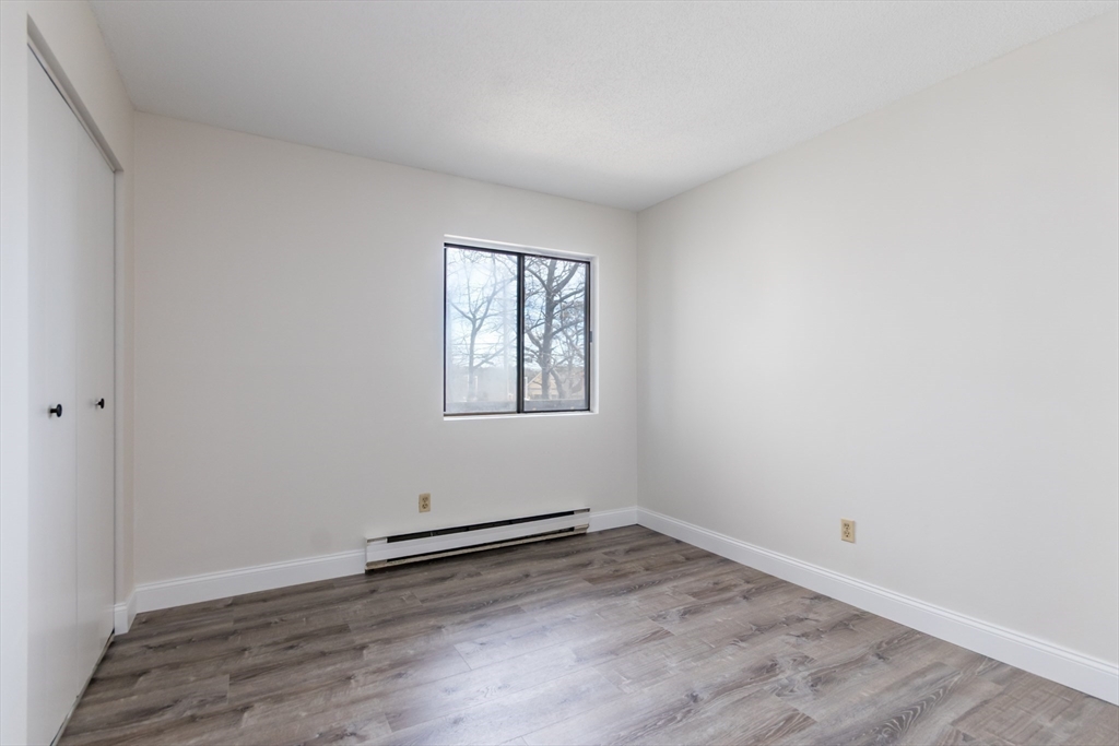 800 Bearses Way, Unit 3NE Hyannis, MA 02601 - Photo 13 of 20 an empty room with wooden floor and windows