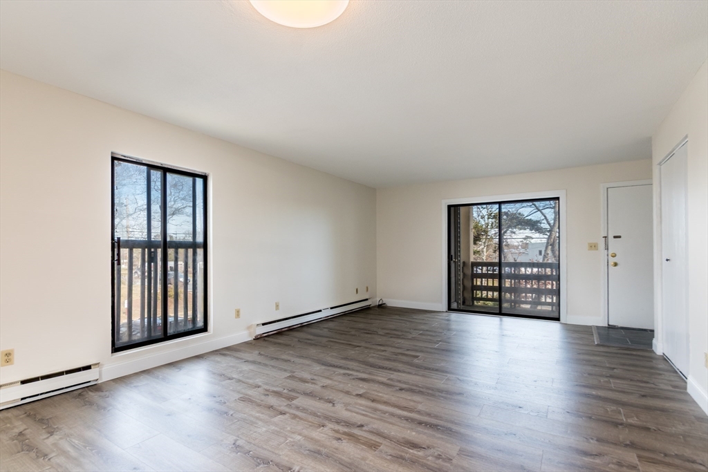 800 Bearses Way, Unit 3NE Hyannis, MA 02601 - Photo 2 of 20 an empty room with wooden floor and windows