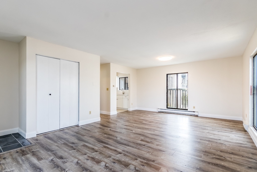 800 Bearses Way, Unit 3NE Hyannis, MA 02601 - Photo 3 of 20 a view of an empty room with window and wooden floor