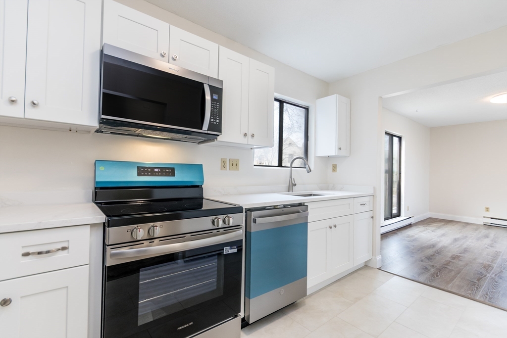800 Bearses Way, Unit 3NE Hyannis, MA 02601 - Photo 5 of 20 a kitchen with stainless steel appliances a stove microwave and sink