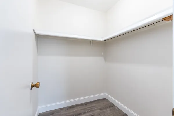 a view of a room with wooden floor