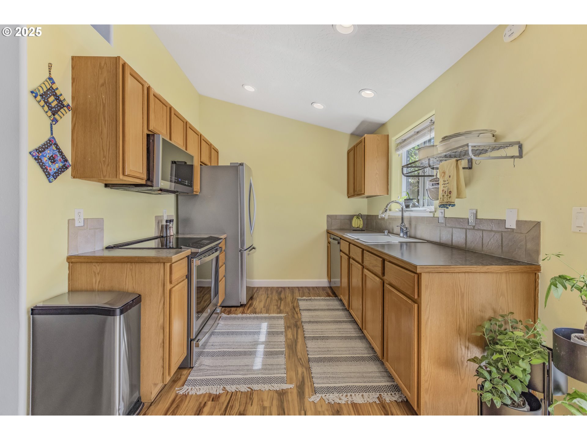 1580 South 60th Street Springfield, OR 97478 - Photo 14 of 36 a kitchen with stainless steel appliances granite countertop a stove a sink and a refrigerator